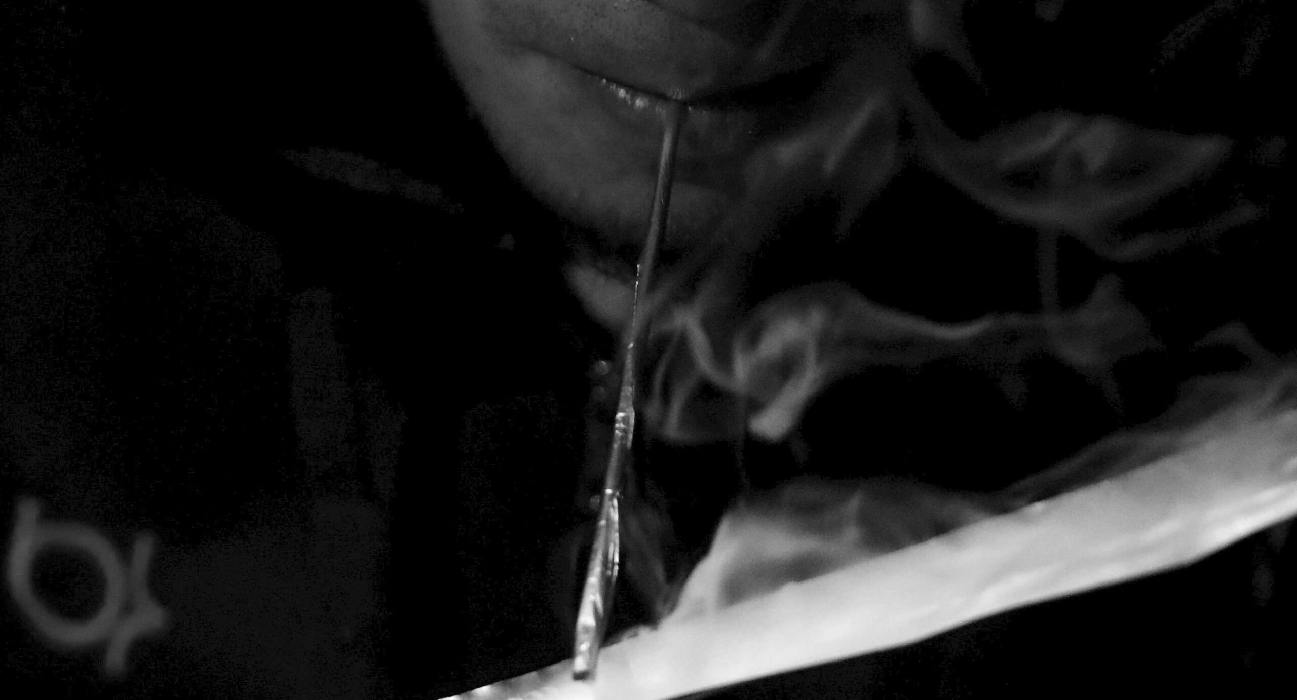 A drug user inhales "Shabu", or methamphetamine, at a drug den in Manila