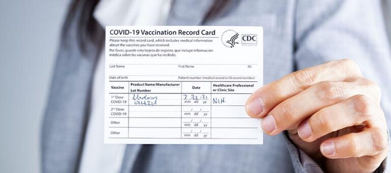 woman-holding-covid-vaccine-card-1